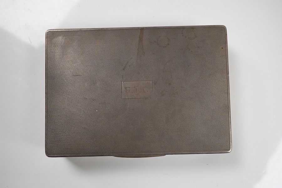 A George V engine turned silver mounted rectangular cigarette box, by William Neale Ltd, Birmingham, 1935, 16.2cm.